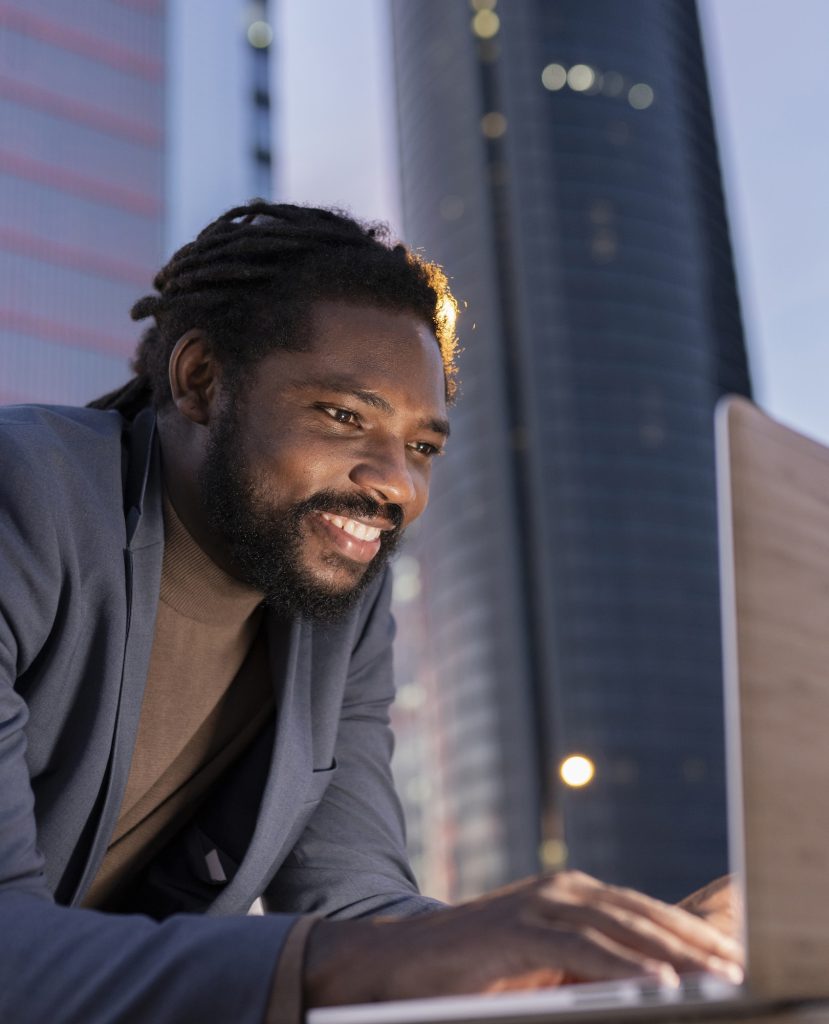 man in city with laptop business at night