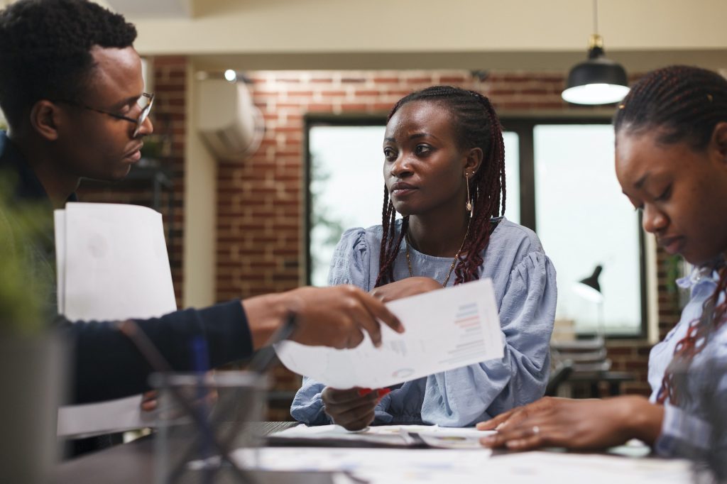 Marketing company team leader briefing coworkers about startup project presentation